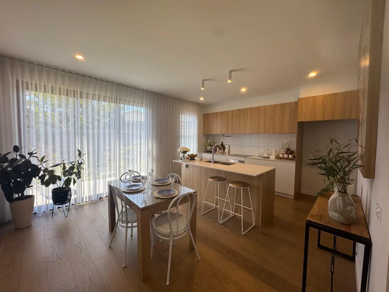 Chapel Drive, Wantirna South — kitchen and dining area with a timber island bench and bar stools